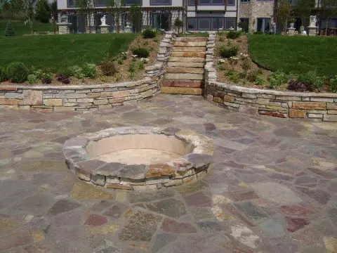 Circular fire pit surrounded by natural stone in outdoor space